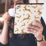a girl is holding and viewing personalized iPad folio case with Christmas design
