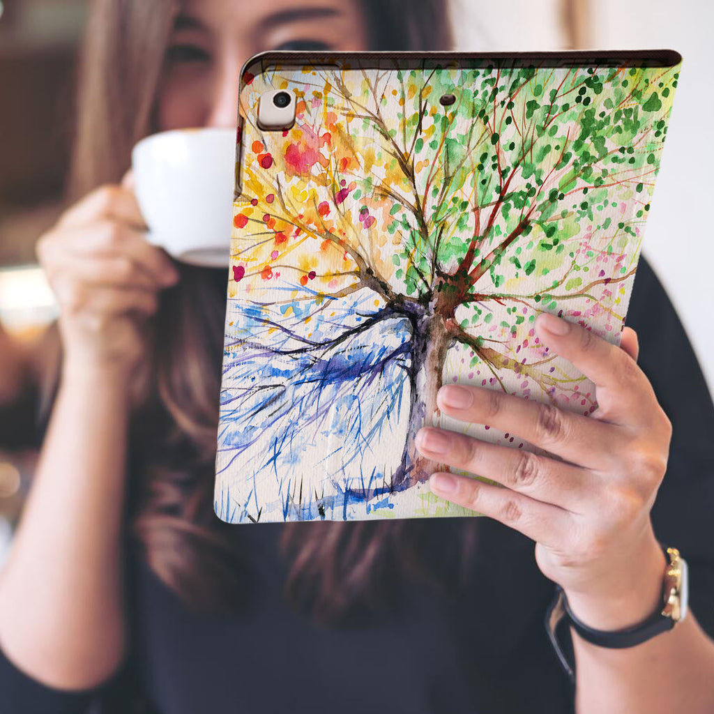 a girl is holding and viewing personalized iPad folio case with Watercolor Flower design