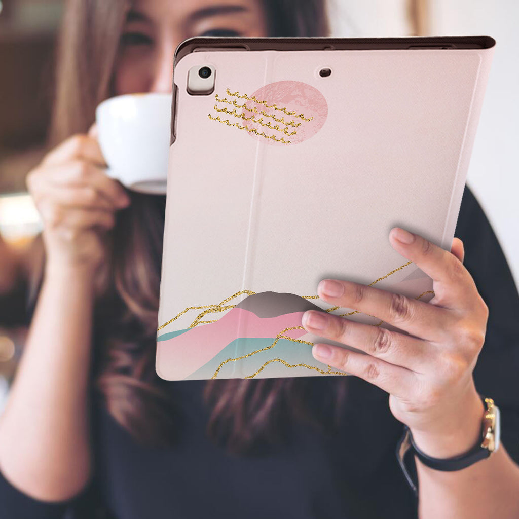 a girl is holding and viewing personalized iPad folio case with Marble Art design