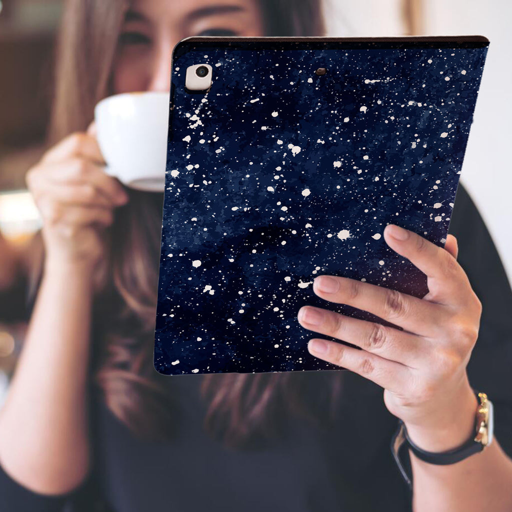 a girl is holding and viewing personalized iPad folio case with Galaxy Universe design