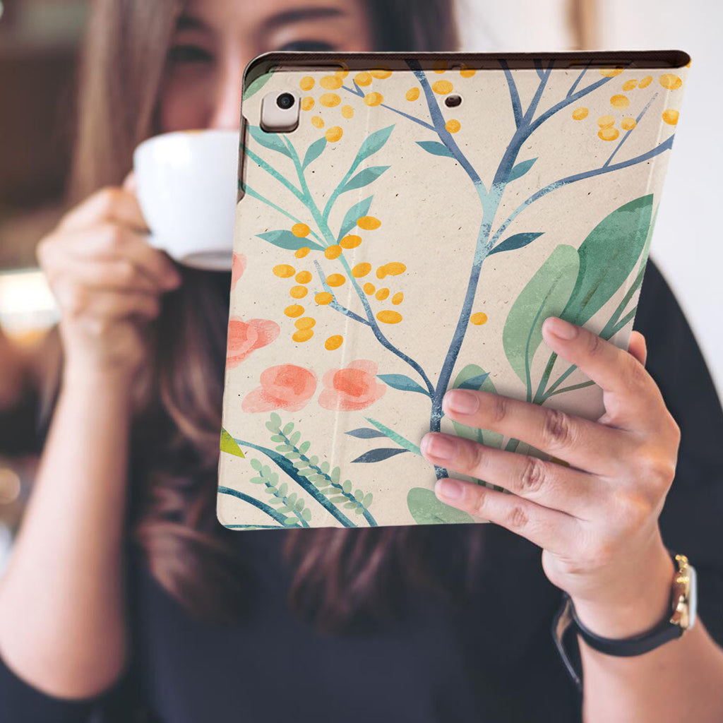 a girl is holding and viewing personalized iPad folio case with Pink Flower design
