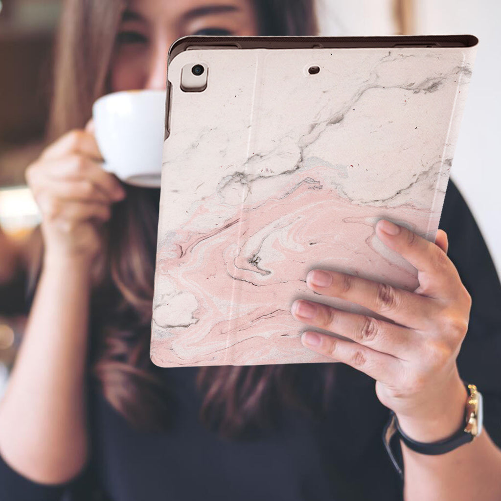 a girl is holding and viewing personalized iPad folio case with Pink Marble design