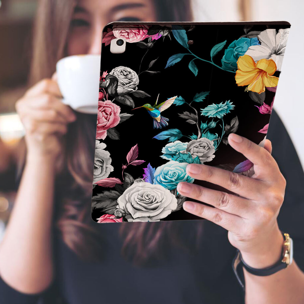 a girl is holding and viewing personalized iPad folio case with Black Flower design