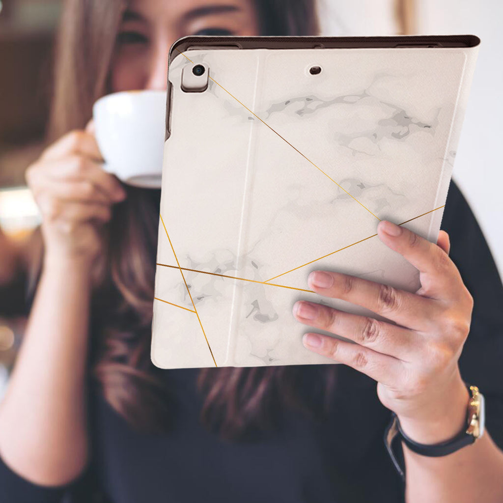 a girl is holding and viewing personalized iPad folio case with Marble 2020 design