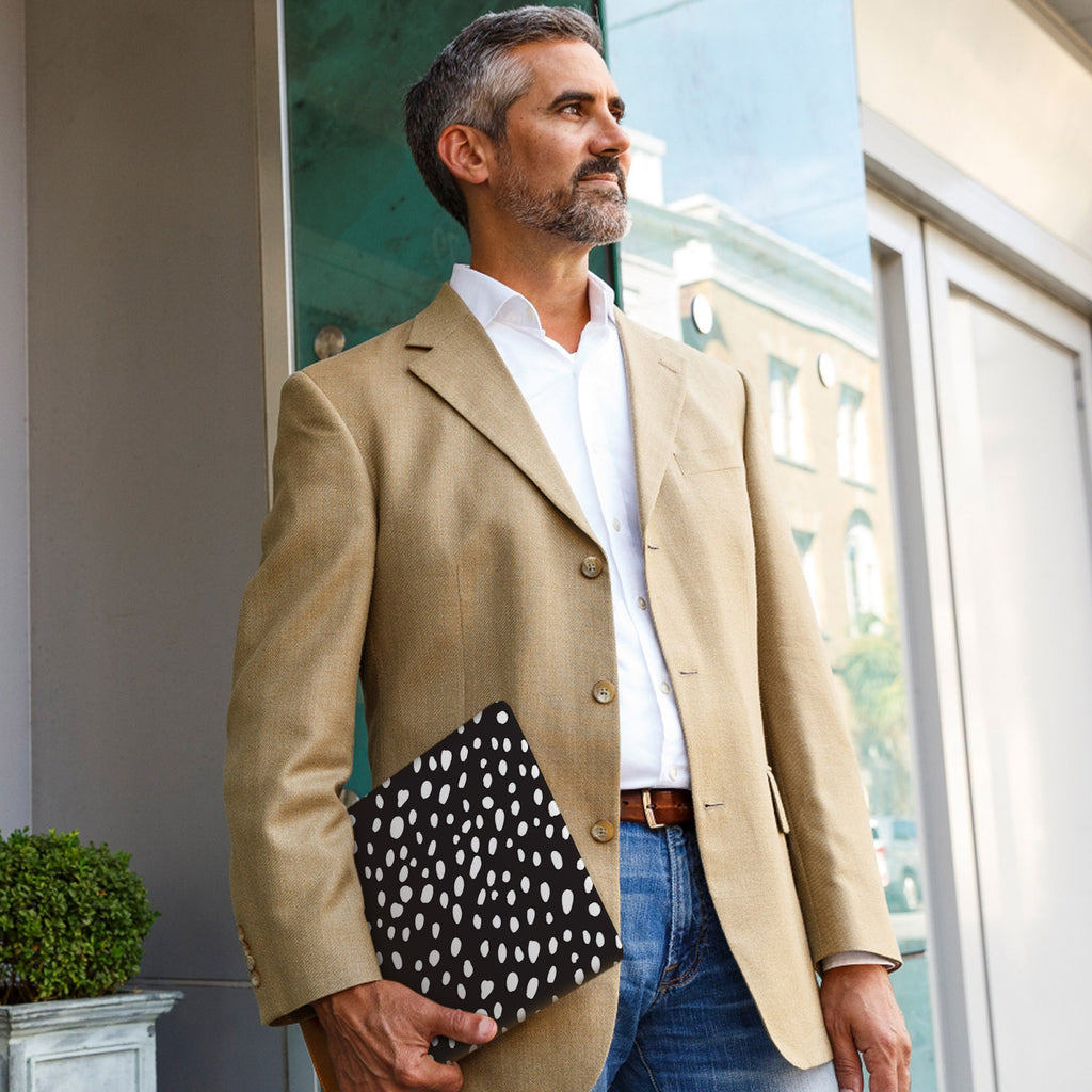 A business man carrying personalized microsoft surface case with Polka Dot design in the park
