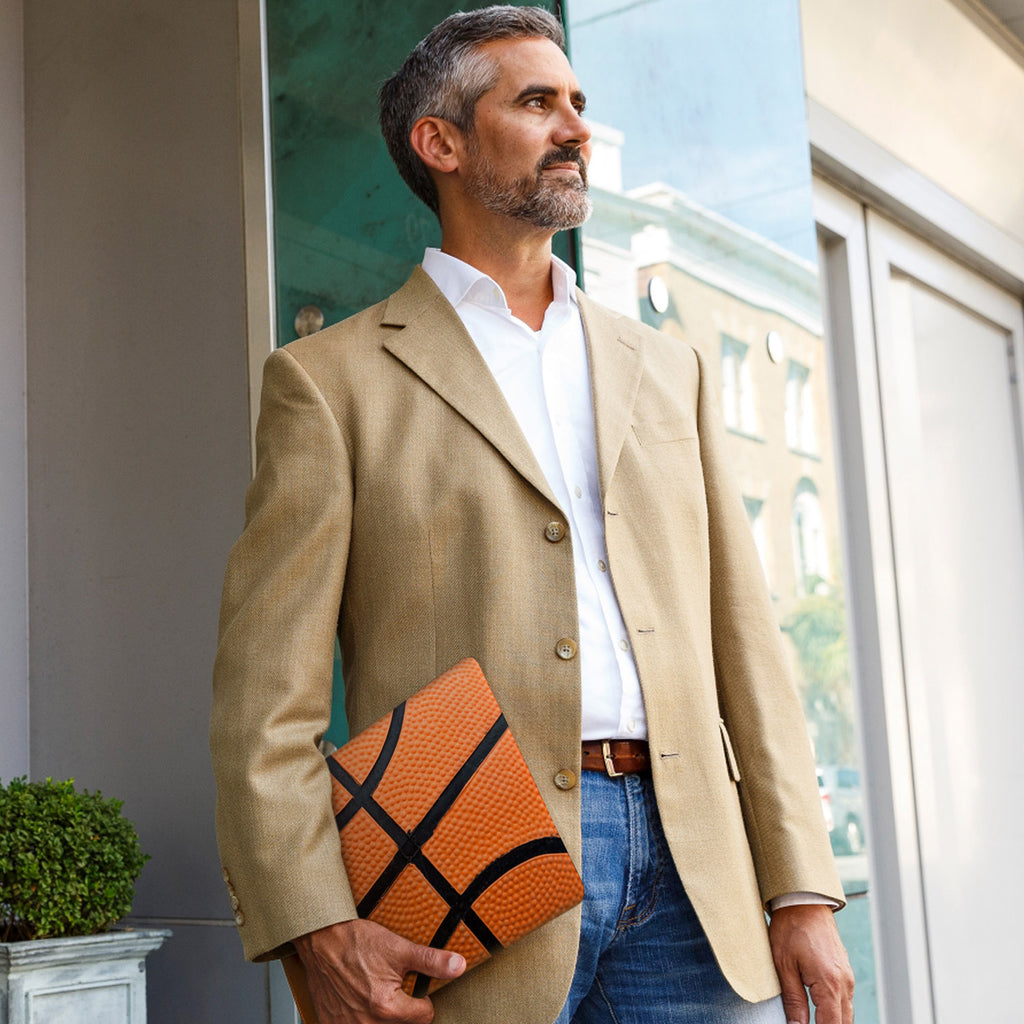 A business man carrying personalized microsoft surface case with Sport design in the park